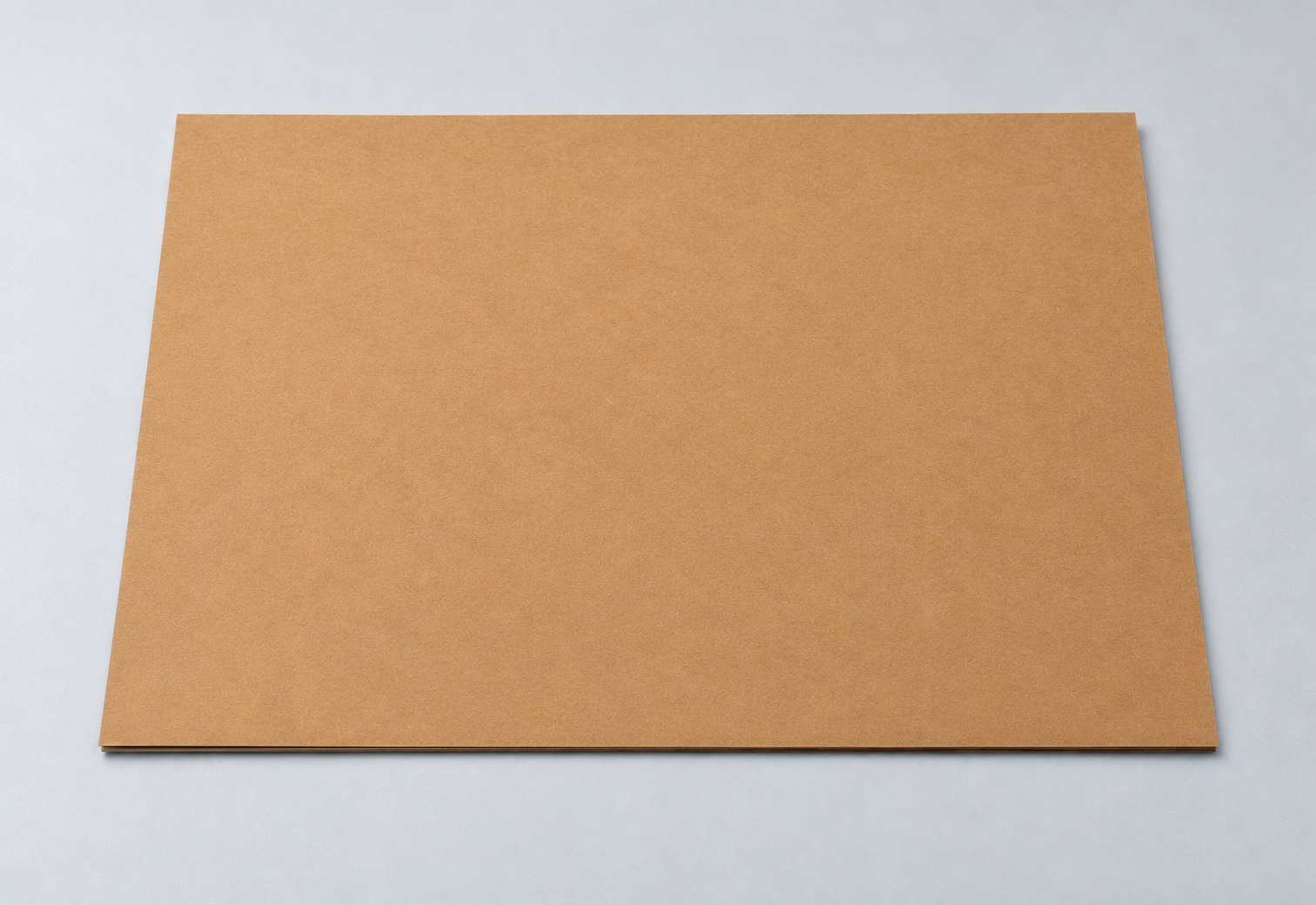 Red-brown kraft paper sample sheet on a light gray studio surface
